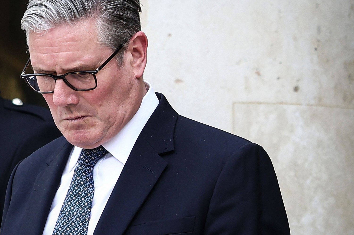 (FILES) Britain's Prime Minister Keir Starmer reacts as he prepares to leave the Elysee Presidential Palace in Paris on April 17, 2026. British Prime Minister Keir Starmer promised on May 9, 2026, he would "listen to voters" after his Labour party received a historic drubbing in local and regional elections. (Photo by Tom Nicholson / POOL / AFP)