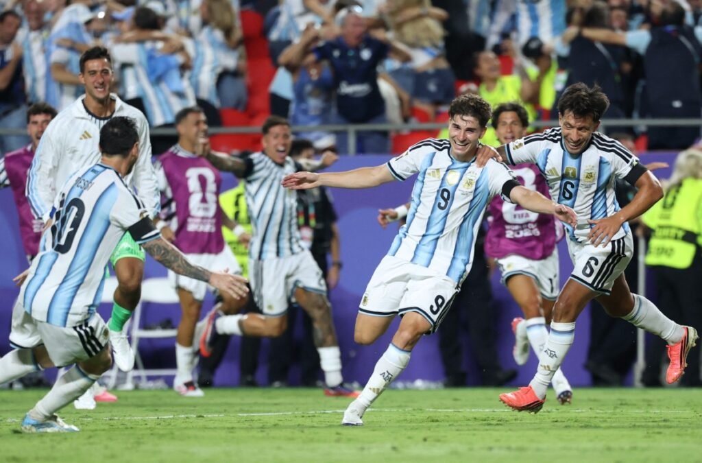 Argentina's forward #09 Julian Alvarez celebrates scoring his team's second goal with Argentina's forward #10 Lionel Messi and Argentina's defender #06 Lisandro Martinez during the 2026 World Cup football tournament quarter-final match between Argentina and Switzerland at the Kansas City Stadium in Kansas City on July 11, 2026.  (Photo by Thomas COEX / AFP)