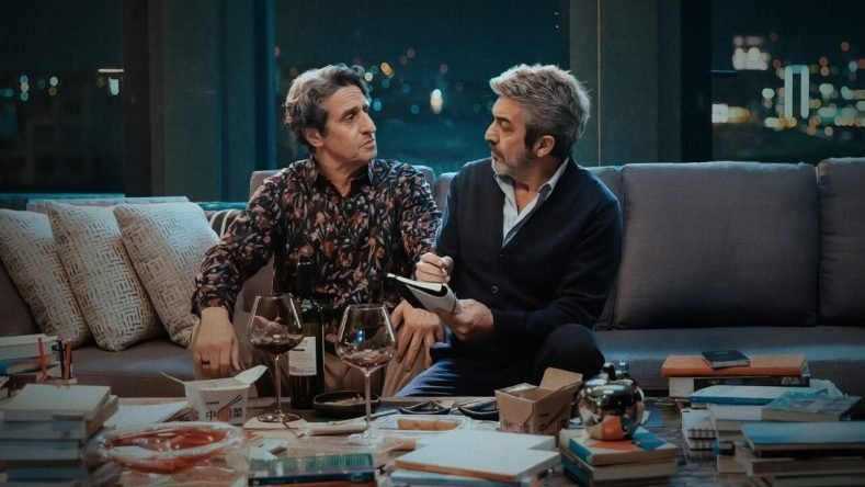 La imagen muestra a Ricardo Darín (en el rol del psicoanalista Ulises Verón) y a Diego Peretti (en el rol del escritor Martín Bouchard) en una escena de la película argentina Lo dejamos acá (2026).