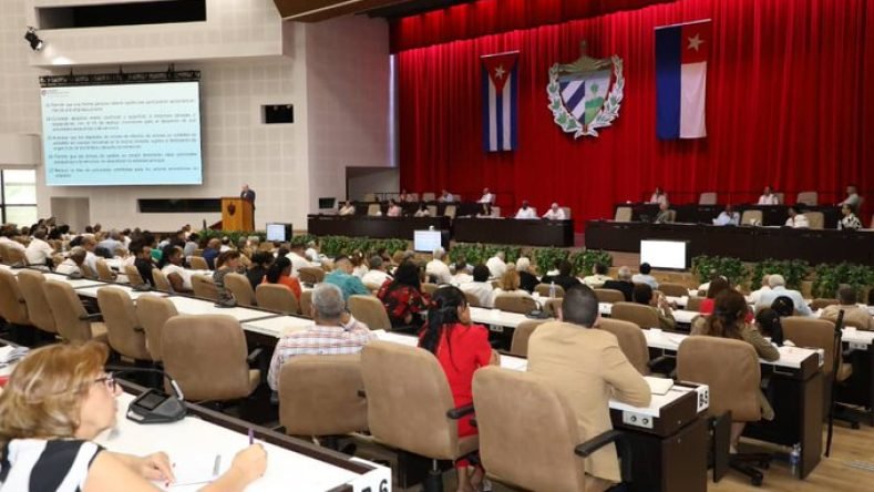 Esta imagen muestra una sesión de la Asamblea Nacional del Poder Popular de Cuba en el Palacio de las Convenciones de La Habana, donde se debaten medidas económicas como la apertura de empresas estatales al capital privado.