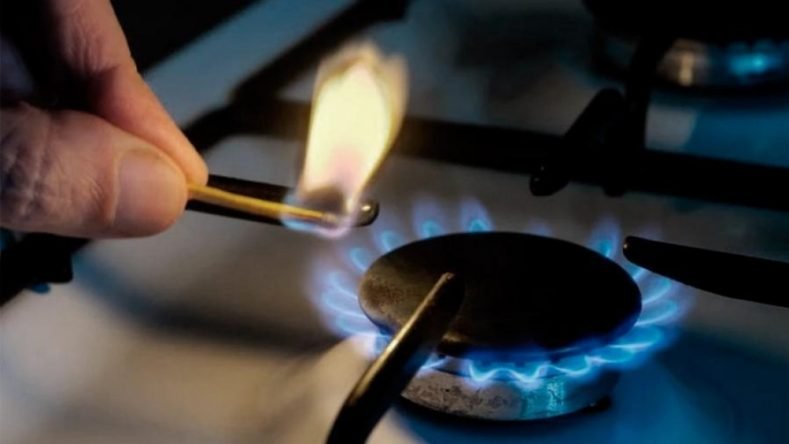 Imagen ilustrativa de una mano con un fósforo encendiendo una hornalla